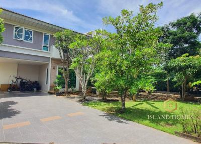 Spacious two-story house with front garden and paved driveway