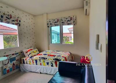 Cozy bedroom with natural light and colorful wallpaper