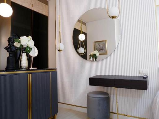 Elegant entrance hall with decorative mirror and modern lighting