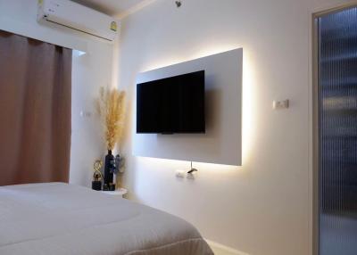 Cozy bedroom with wall-mounted TV and modern decor