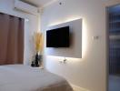 Cozy bedroom with wall-mounted TV and modern decor