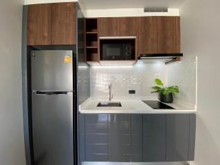 Modern kitchen with stainless steel appliances and dark wood cabinetry