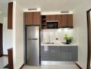 Modern kitchen with stainless steel appliances and wooden cabinets