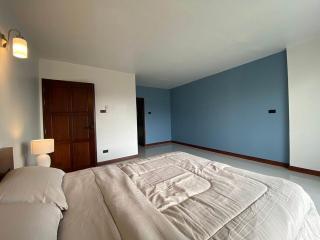 Spacious bedroom with blue walls and large bed