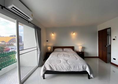 Modern bedroom with large bed and city view