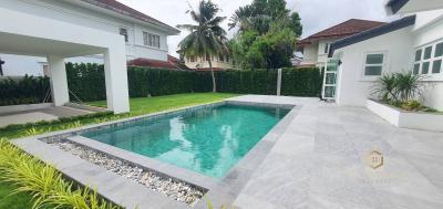 Spacious backyard with a swimming pool and tiled patio area