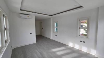 Spacious and bright unfurnished living room with modern flooring and recessed lighting