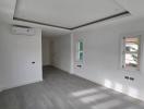 Spacious and bright unfurnished living room with modern flooring and recessed lighting