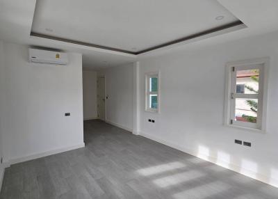 Spacious and bright unfurnished living room with modern flooring and recessed lighting