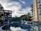 Apartment complex with swimming pool and modern facilities under a clear sky