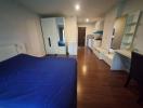 Spacious bedroom with wooden floors and plenty of storage