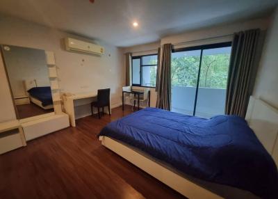 Spacious bedroom with a large bed and natural light