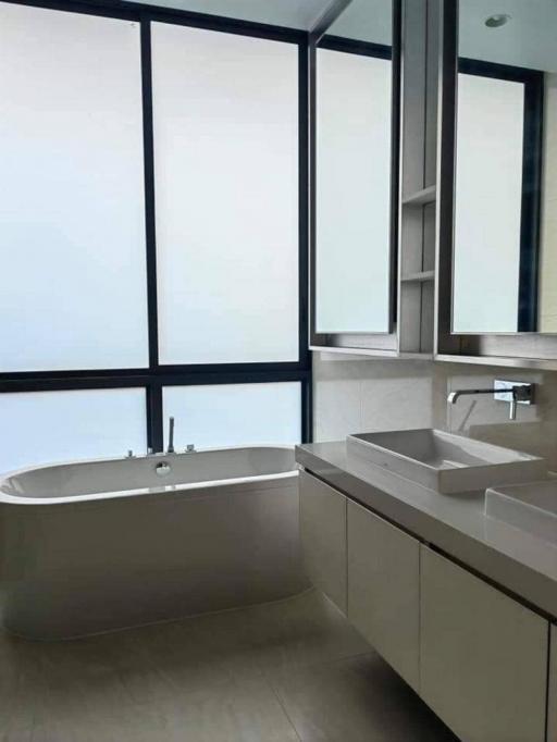 Modern bathroom with large windows and bathtub