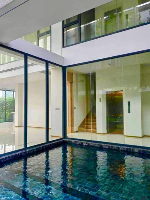 Modern home with large glass windows and indoor pool