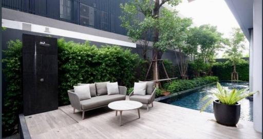 Modern outdoor patio with seating area and pool