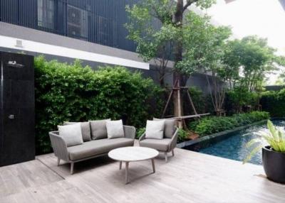 Modern outdoor patio with seating area and pool