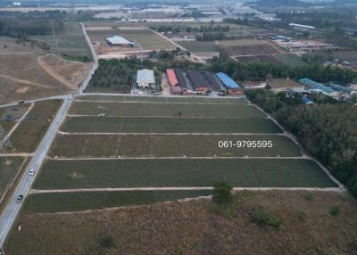 Aerial view of a large property with farmland and surrounding buildings