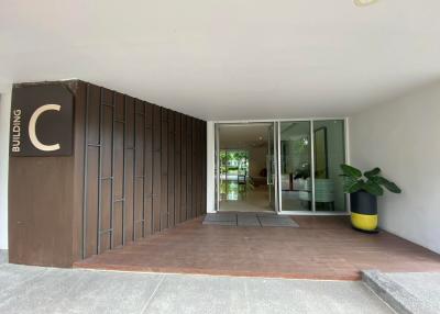 Modern building entrance with glass doors and potted plant