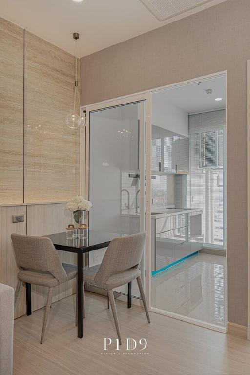 Modern dining area with glass partition and wooden accents