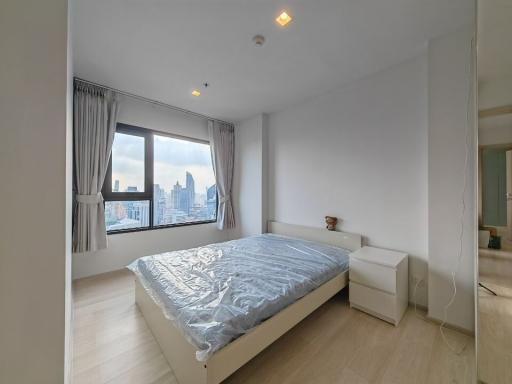 Modern bedroom with city view from window