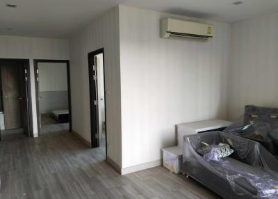 Spacious bedroom with laminate flooring and air conditioning