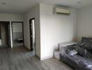 Spacious bedroom with laminate flooring and air conditioning
