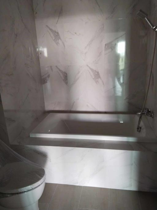 Modern marble bathroom with built-in bathtub and shower