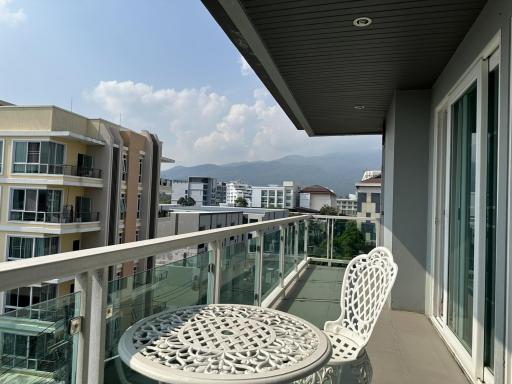 Spacious balcony with outdoor seating and scenic mountain view