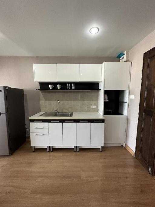 Modern kitchen with stainless steel appliances and wooden flooring