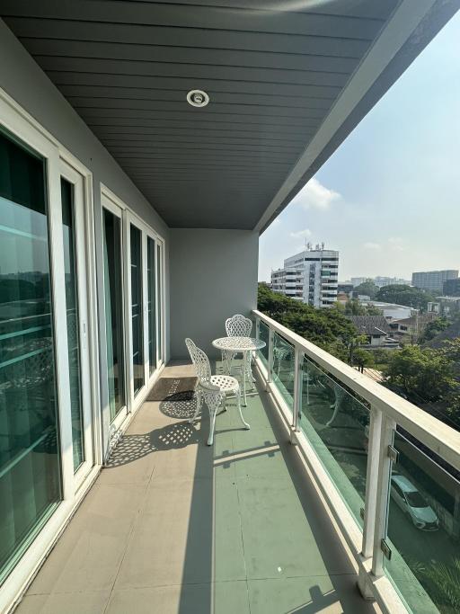 Spacious balcony with outdoor seating and urban view