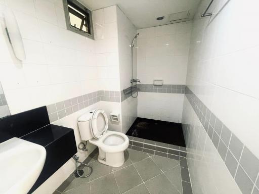 Clean and white-tiled bathroom with modern fixtures