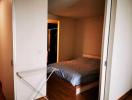 Cozy bedroom with wooden furnishing and a clothes rack