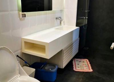 Modern bathroom with sleek sink and black shower area