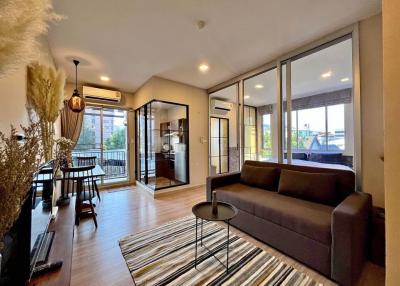 Cozy and modern living room with balcony access and ample natural light