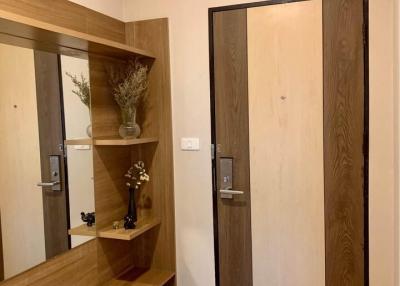 Modern entryway with wooden elements and a large mirror