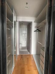 Spacious walk-in closet leading to a modern bathroom