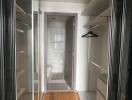 Spacious walk-in closet leading to a modern bathroom