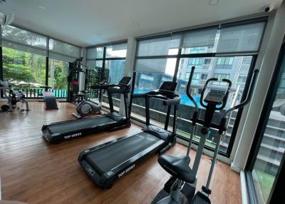 Home gym with various exercise equipment and large windows
