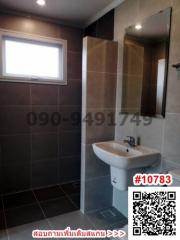 Modern bathroom with neutral color tiles and natural light