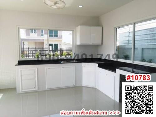 Spacious modern kitchen with black countertops and white cabinetry