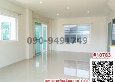 Spacious and well-lit empty room with glossy tiled flooring