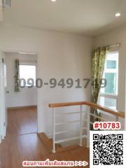 Spacious bedroom with ample natural light and hardwood flooring