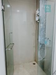 Modern bathroom with glass shower and tiled walls