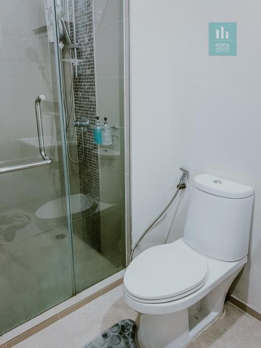 Modern bathroom with glass shower enclosure and toilet