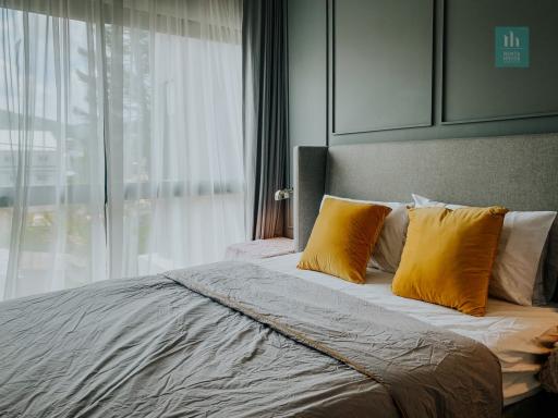 Cozy modern bedroom with large window and elegant decor