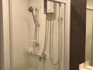 Modern bathroom with a glass shower stall and wall-mounted water heater