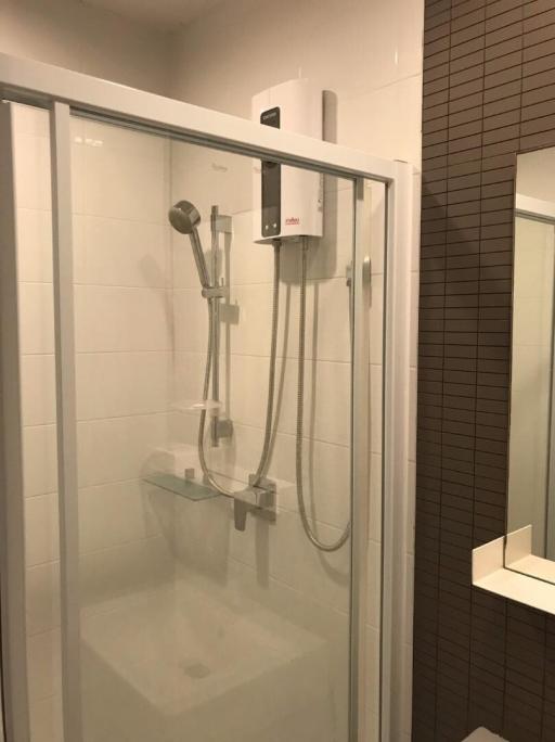 Modern bathroom with a glass shower stall and wall-mounted water heater