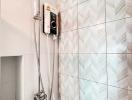Modern bathroom with wall-mounted shower and white patterned tiles