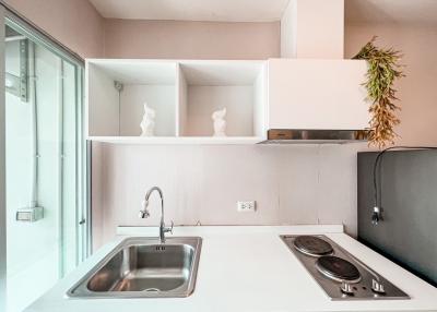 Modern kitchen with stainless steel sink and electric stove