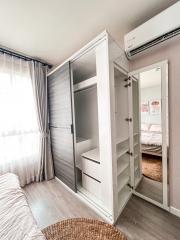 Compact bedroom with built-in wardrobe and air conditioning